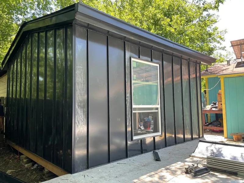 Black standing seam metal wall panels for Roof Inspection in Wharton